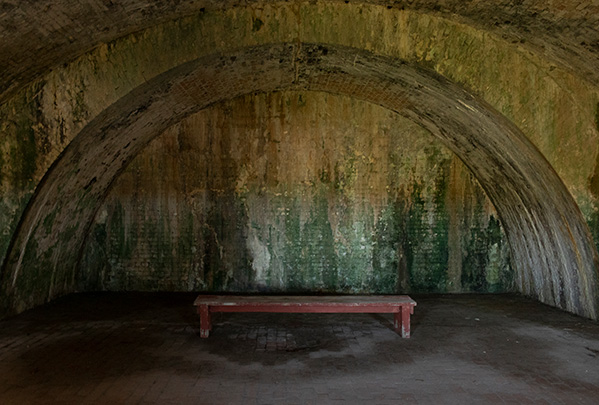 DSLR overexposed photo of bench in dark corner of Fort Pickens